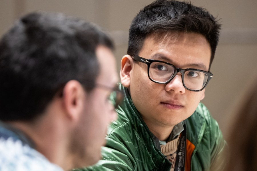A researcher listening attentively during a session at a Keystone Symposia meeting