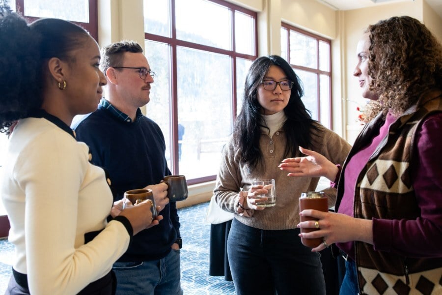Early-career researchers talking over coffee at a Keystone Symposia meeting